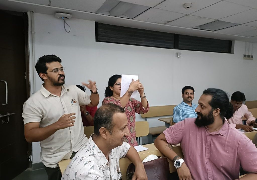 Participants at IITGN workshop sharing stories based on prompted drawings